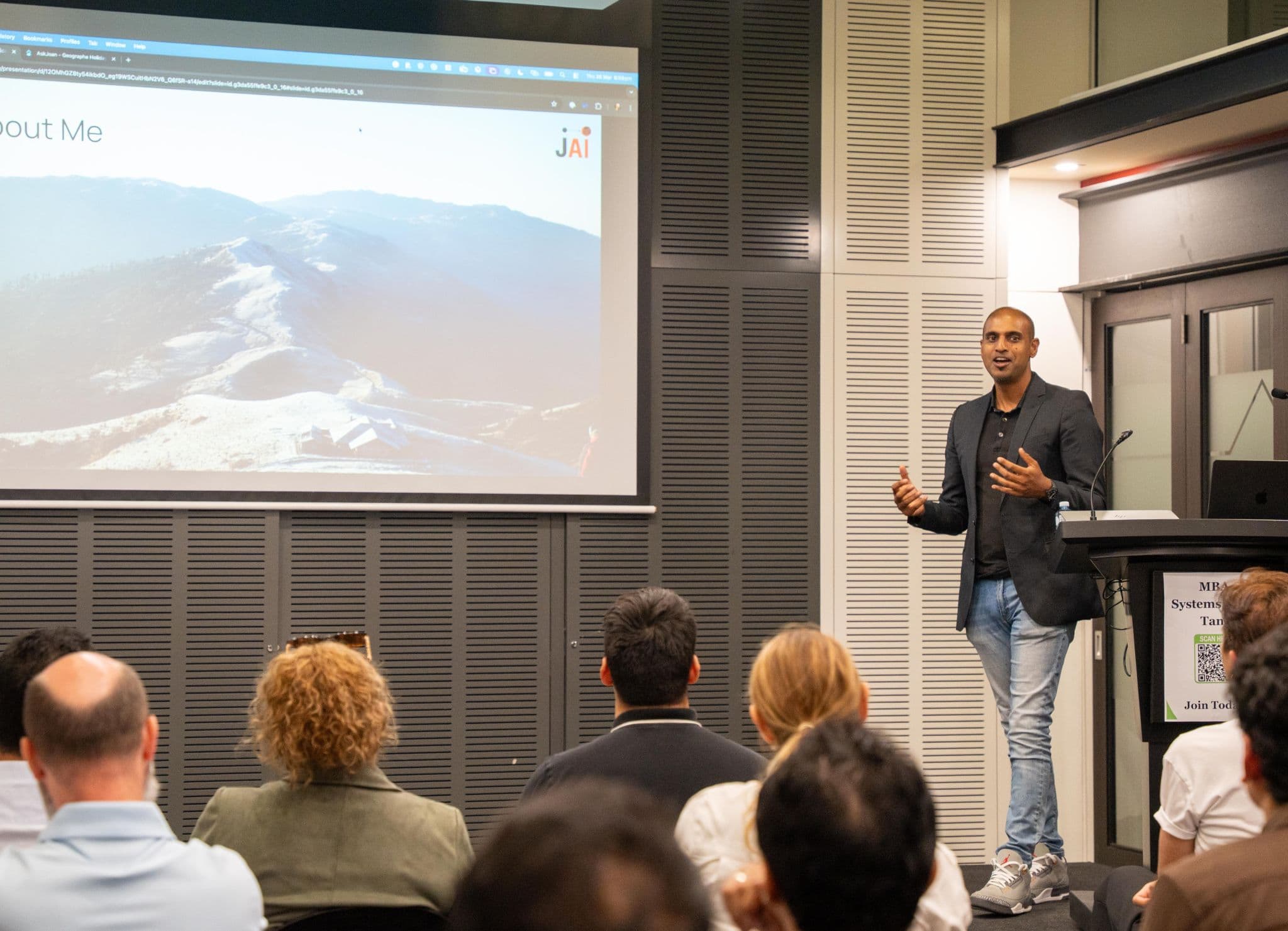 Mo Jaimangal presenting practical AI education to a business audience